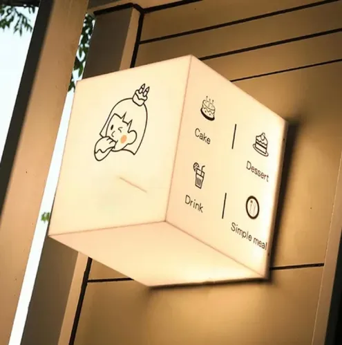 Caja de luz cúbica de tres caras, con pictogramas de carta impresos y luz interior uniforme.